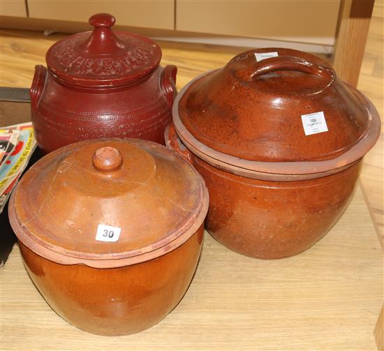 Three late Victorian terracotta cream pans, with wooden covers tallest 33cm